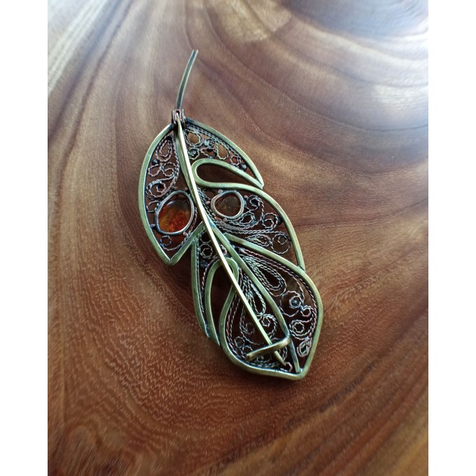 Brass feather brooch with amber