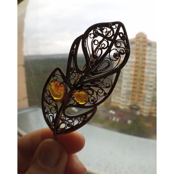 Brass feather brooch with amber