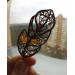 Brass feather brooch with amber