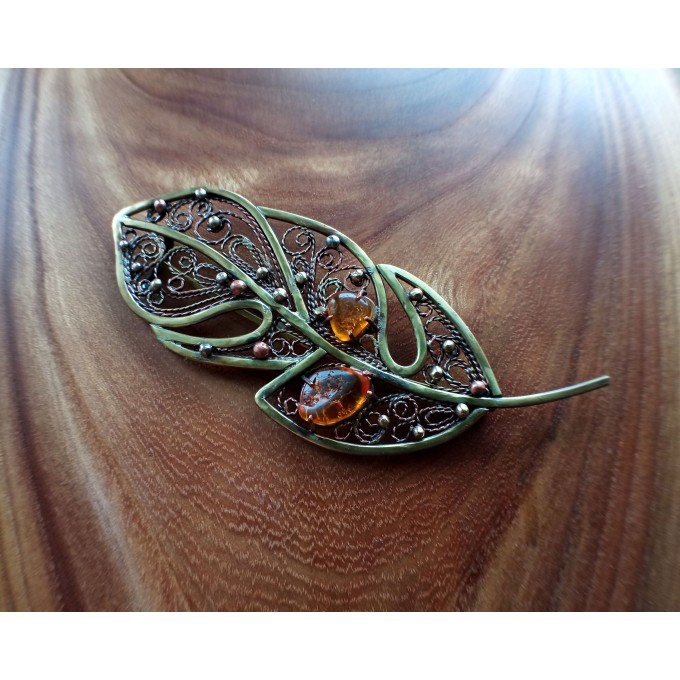 Brass feather brooch with amber