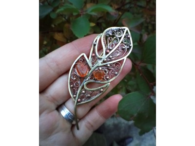 Brass feather brooch with amber