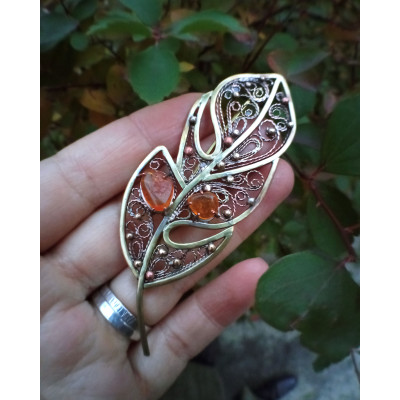 Brass feather brooch with amber
