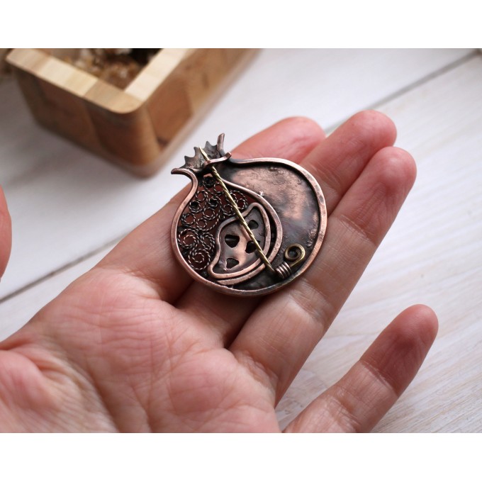 Copper filigree pomegranate brooch with garnet