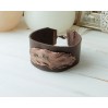Leather bracelet with copper feather